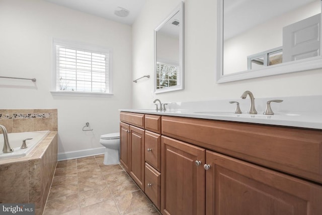 bathroom with toilet, double vanity, a bath, and a sink