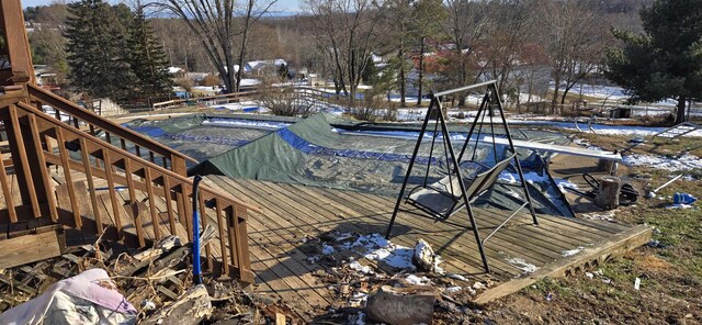 snow covered pool with a deck