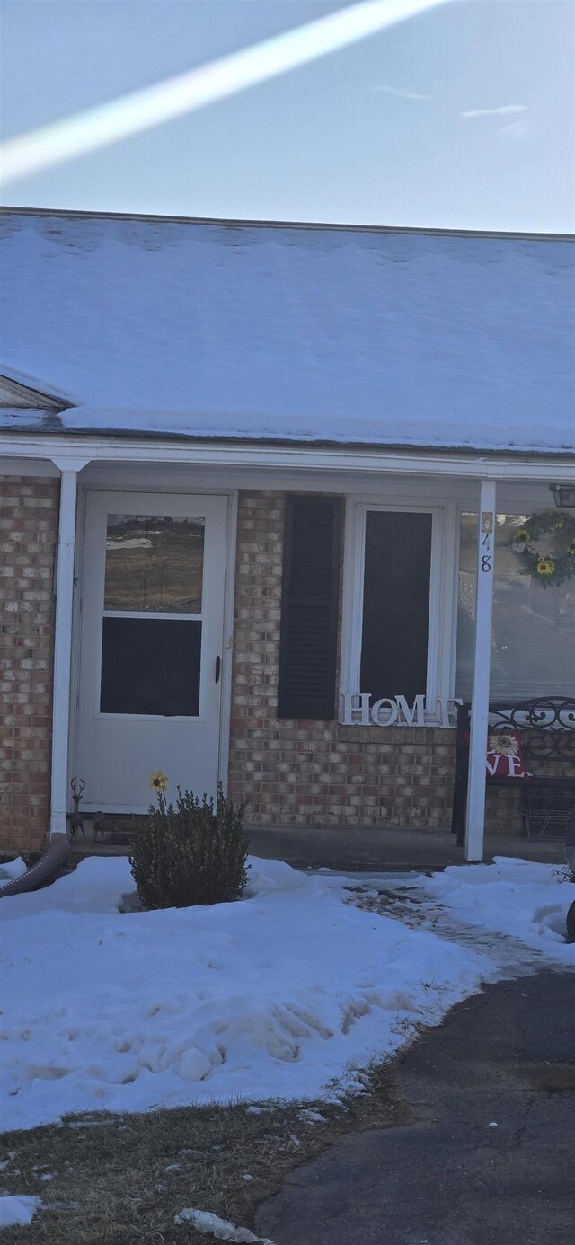 view of snow covered property entrance