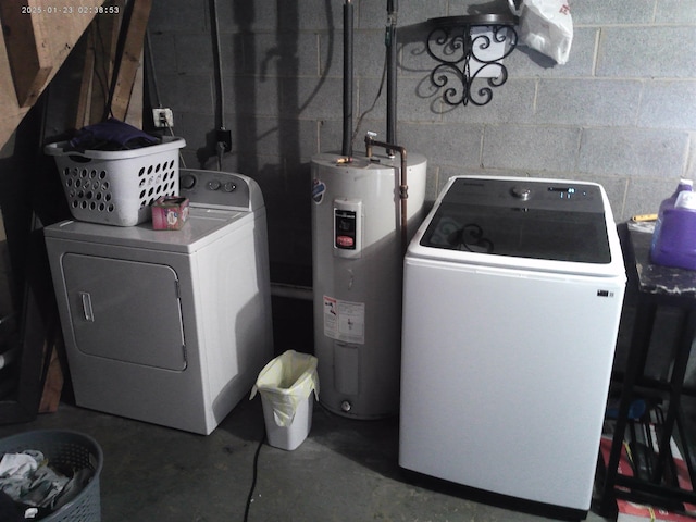 washroom featuring water heater and washing machine and clothes dryer