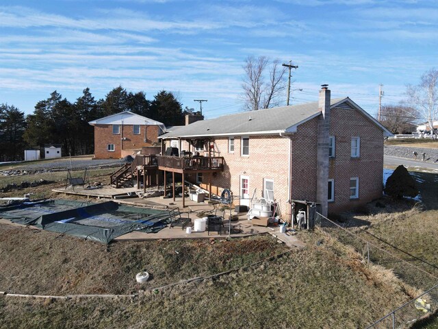 rear view of house with a patio and a deck