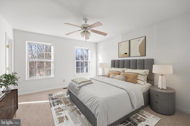 carpeted bedroom with ceiling fan and baseboards