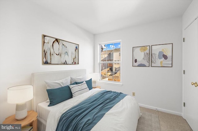 carpeted bedroom with baseboards