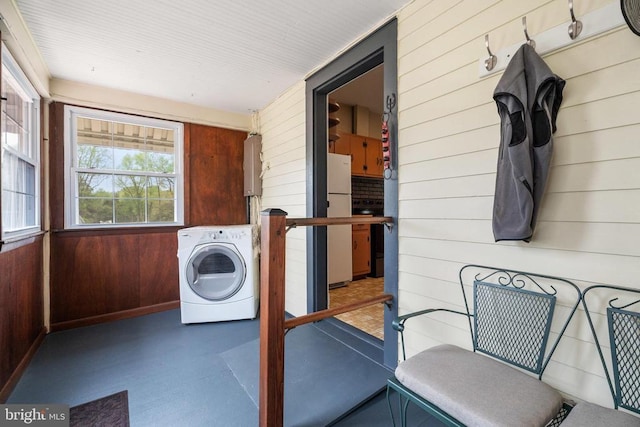 laundry room with washer / clothes dryer, wooden walls, laundry area, and water heater