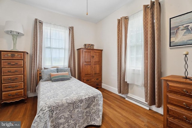 bedroom with wood finished floors and baseboards