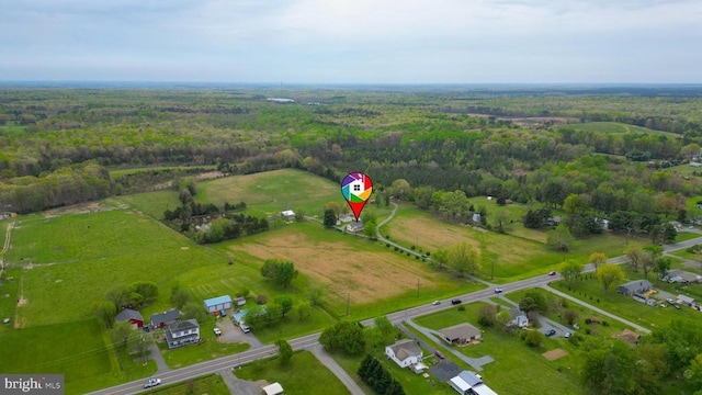 drone / aerial view featuring a rural view and a forest view