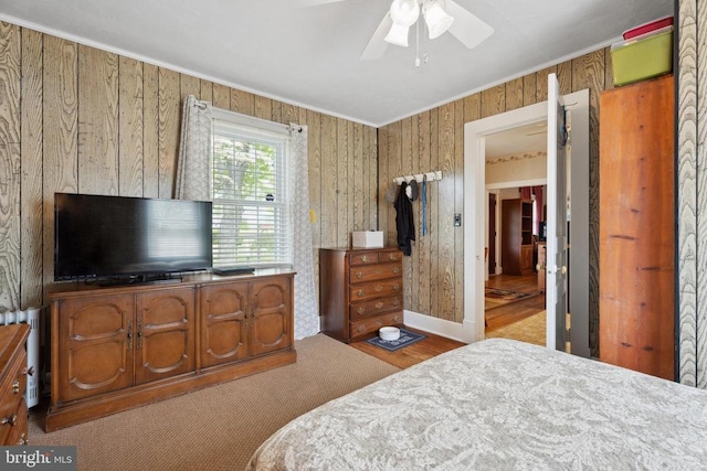 bedroom featuring a ceiling fan, baseboards, and ornamental molding