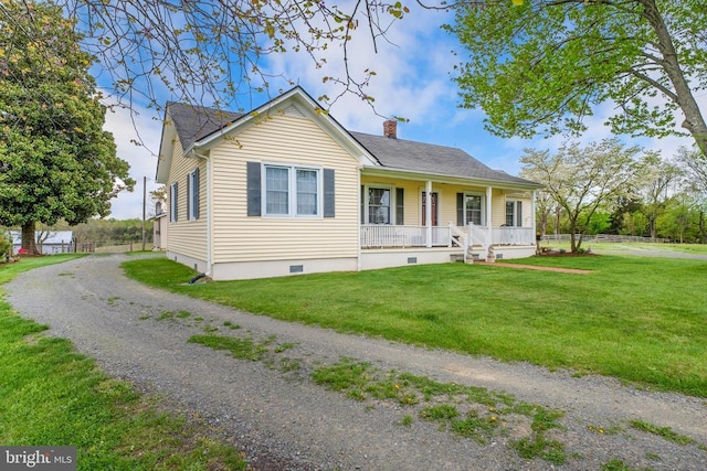 view of front of home featuring crawl space, a porch, a chimney, and a front lawn