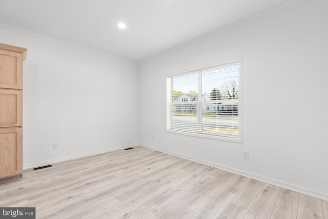 empty room with recessed lighting, ornamental molding, light wood finished floors, baseboards, and visible vents