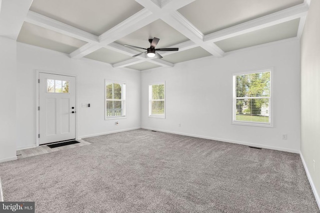 interior space with coffered ceiling, a healthy amount of sunlight, and baseboards