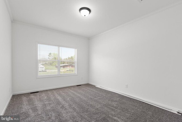 spare room featuring visible vents, crown molding, carpet flooring, and baseboards