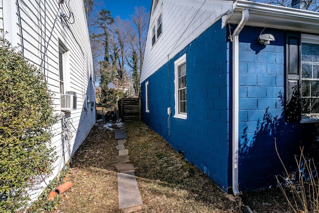 view of property exterior with concrete block siding