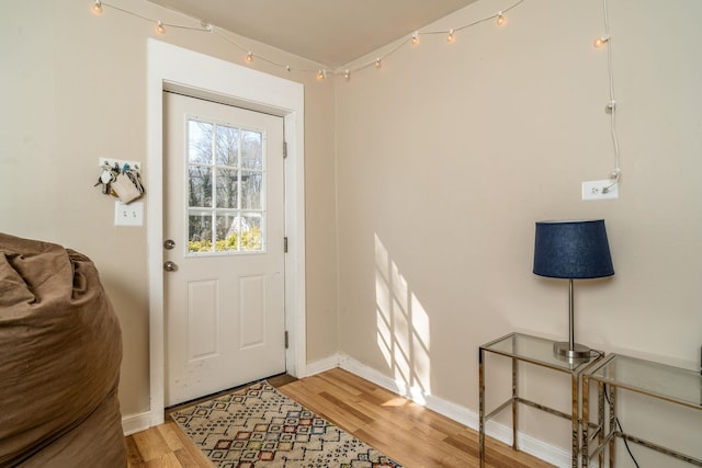 entryway featuring light wood finished floors and baseboards