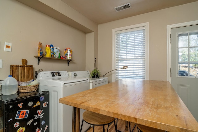 laundry room with laundry area, visible vents, and separate washer and dryer