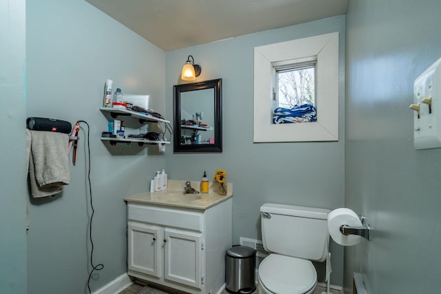 half bathroom featuring toilet and vanity