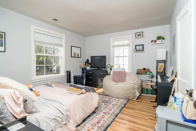 bedroom with wood finished floors and visible vents