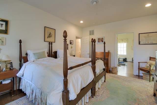 bedroom featuring wood finished floors, visible vents, and recessed lighting