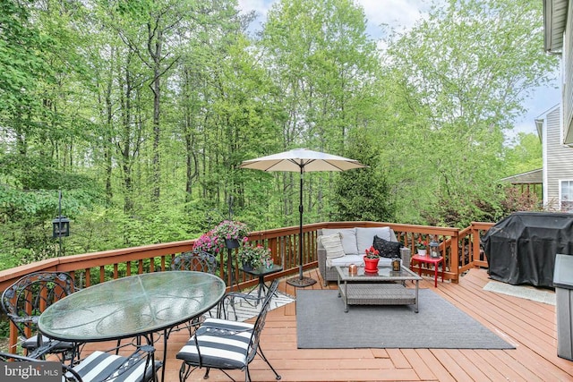 wooden terrace with an outdoor living space, outdoor dining space, and grilling area