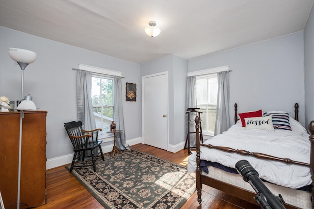bedroom featuring baseboards and wood finished floors