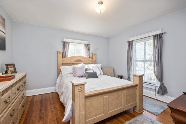 bedroom featuring dark wood-style flooring and baseboards