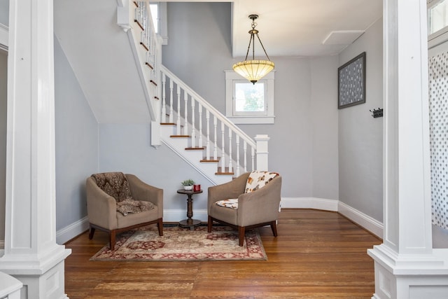 entryway featuring stairway, baseboards, decorative columns, and wood finished floors