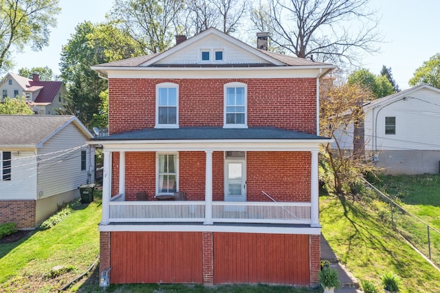 view of front of house with brick siding, fence, a chimney, and a front yard