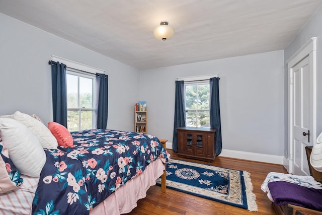 bedroom featuring baseboards and wood finished floors