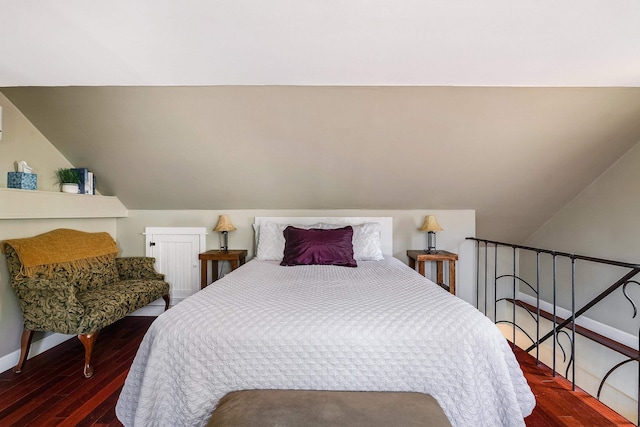 bedroom featuring hardwood / wood-style flooring and lofted ceiling