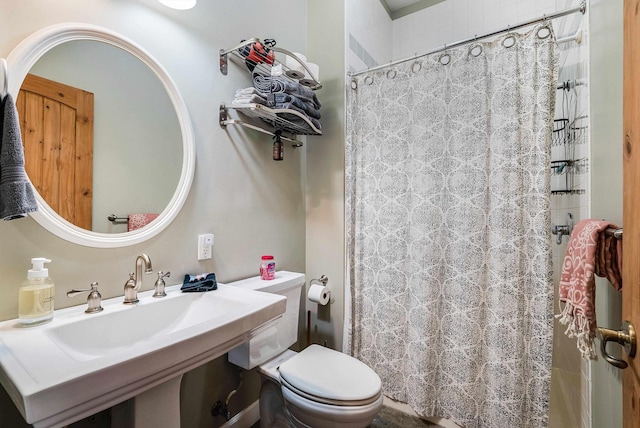 bathroom with a shower with shower curtain, sink, and toilet