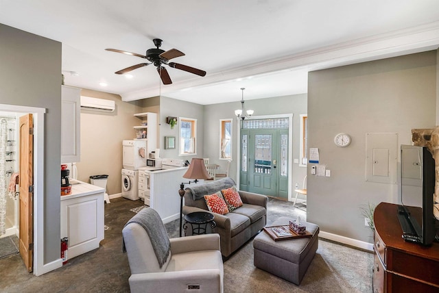 living room featuring ceiling fan with notable chandelier, stacked washer / dryer, and an AC wall unit