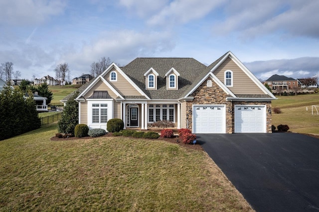 craftsman-style house featuring a garage and a front yard