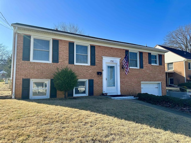 split foyer home with a garage and a front yard