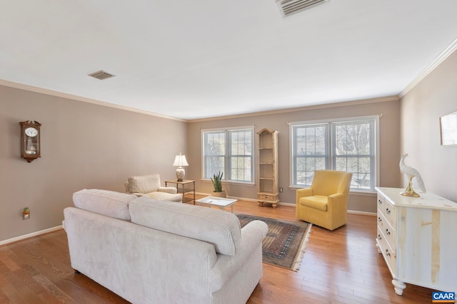 living area featuring ornamental molding, visible vents, and wood finished floors