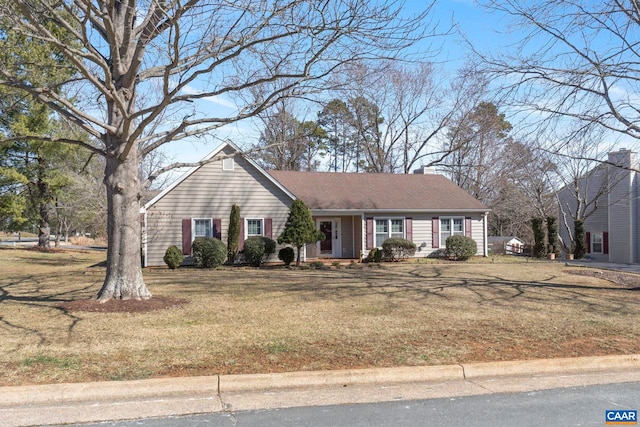 view of front of house featuring a chimney and a front lawn