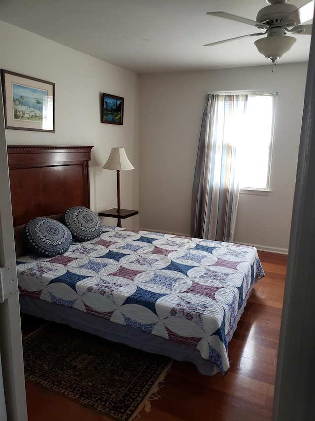 bedroom with ceiling fan and hardwood / wood-style floors