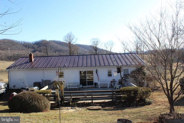 back of property featuring a deck with mountain view