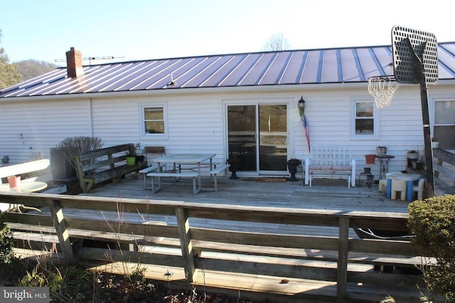 rear view of property with a wooden deck and cooling unit