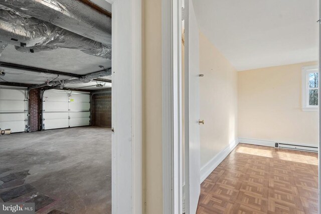 garage featuring baseboards and baseboard heating