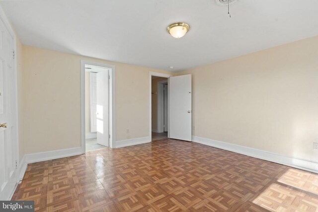 spare room featuring baseboards