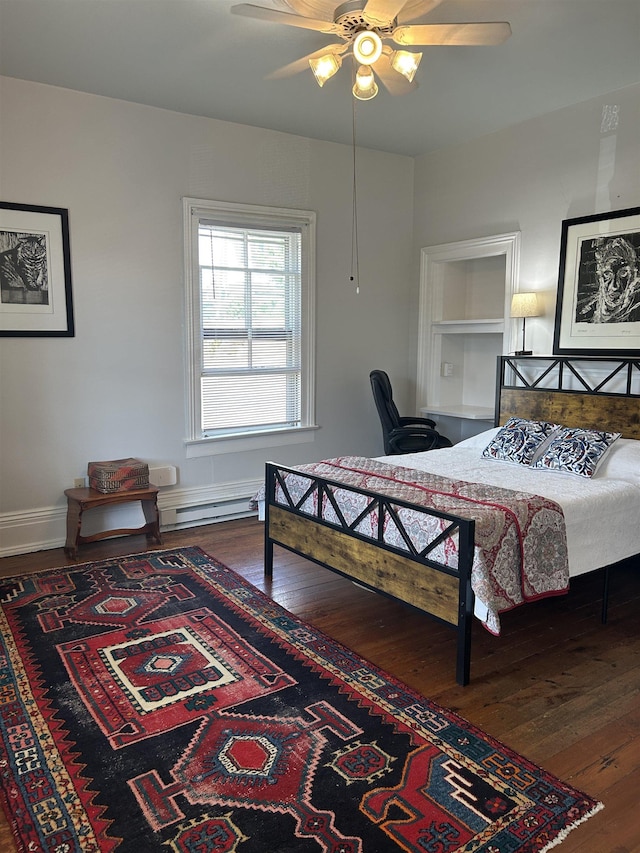 bedroom featuring baseboards, a baseboard radiator, ceiling fan, and hardwood / wood-style floors