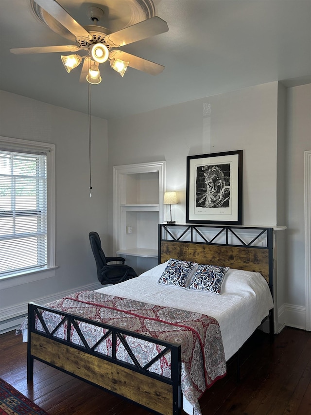 bedroom featuring baseboards, a ceiling fan, and hardwood / wood-style floors