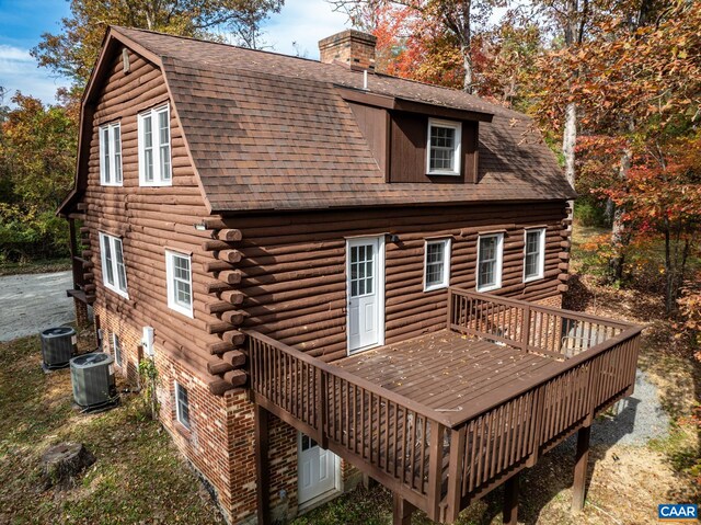 back of property with a wooden deck and central AC unit