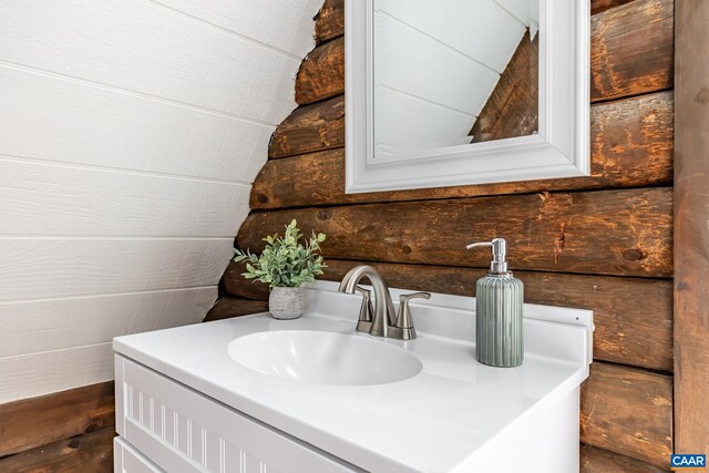 bathroom featuring vanity and vaulted ceiling