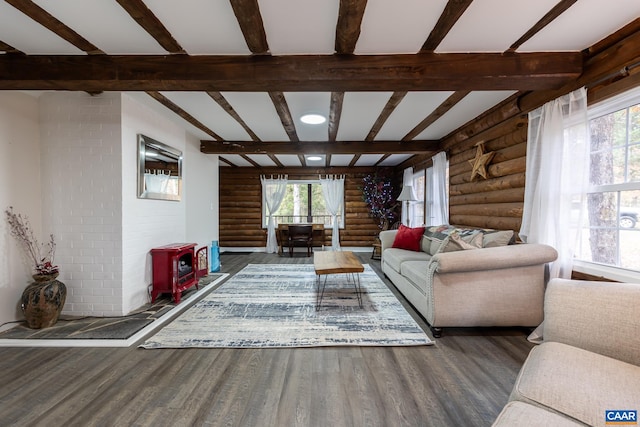 unfurnished living room with dark wood-type flooring, beam ceiling, and rustic walls