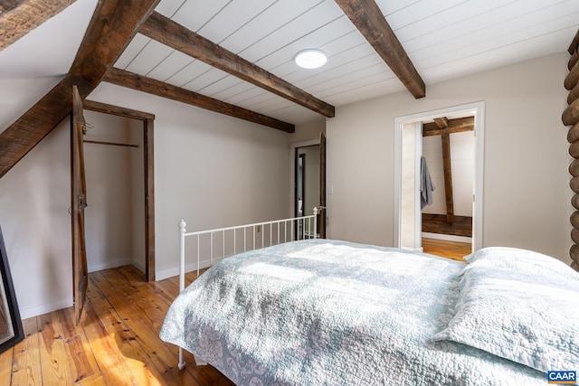 bedroom featuring wood ceiling, beam ceiling, and light hardwood / wood-style floors