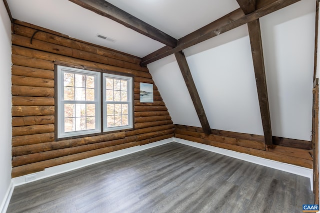 bonus room featuring beam ceiling, dark hardwood / wood-style floors, and log walls