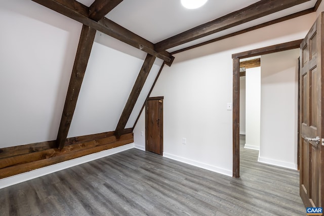 interior space featuring beamed ceiling and wood-type flooring