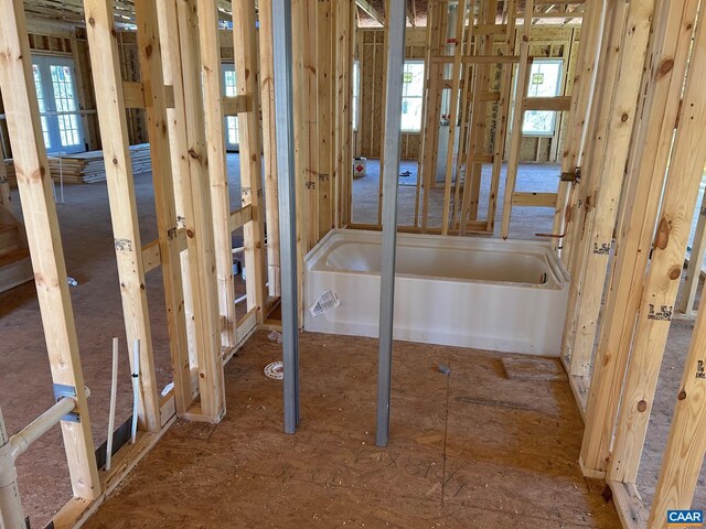 empty room with dark wood-type flooring and a wealth of natural light