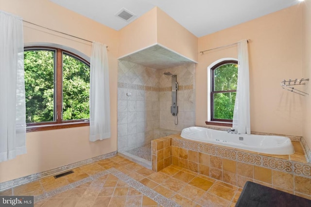 bathroom featuring shower with separate bathtub