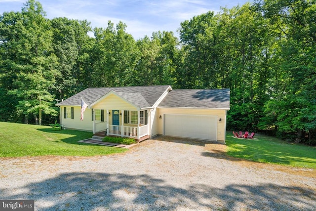 view of front of home with a garage, a front lawn, and a porch